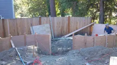 Radius Retaining Wall, Patio & Fire Pit in Bothell, WA: concrete patio and wall work by Redmond Concrete (photo 2 of 6)