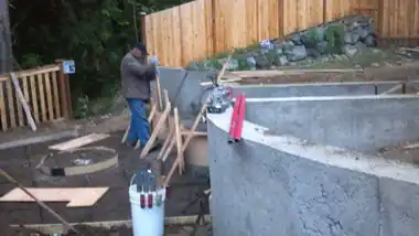 Radius Retaining Wall, Patio & Fire Pit in Bothell, WA: concrete patio and wall work by Redmond Concrete (photo 6 of 6)